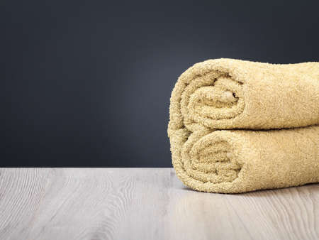 Terry towel as a spa composition on the wooden boards and the gray background.の写真素材