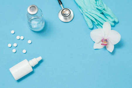 Nasal spray, pills, a glass mercury thermometer, a phonendoscope and nitrile gloves for personal protection. Top view. Virus protective kit concept.の写真素材