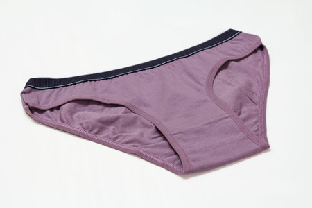 Purple cotton panties on the white background. Women underwear. Top view.