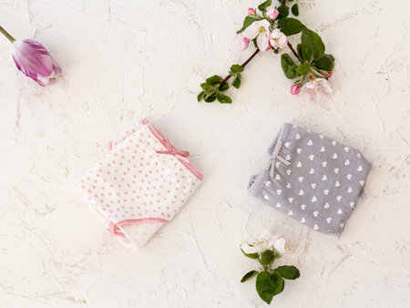 Beautiful womens cotton panties on white background with flowers.