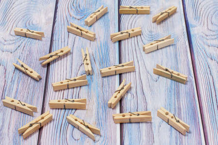Wooden clothes pins on the wooden background. Top view.の写真素材
