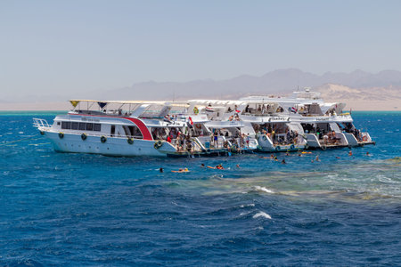 SHARM EL SHEIKH, EGYPT - JUNE 7, 2021: Luxury yachts with tourists in a bay of the Red Sea in Sharm...