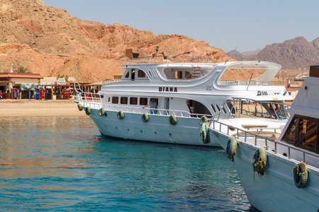 SHARM EL SHEIKH, EGYPT - JUNE 7, 2021: Luxury yacht with tourists on board in the bay of the Red Sea...