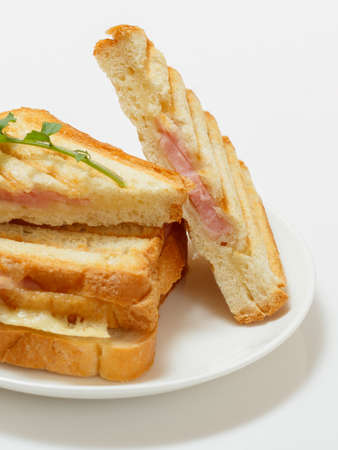 Close-up a homemade grilled cheese sandwiches for breakfast on a clay dish.の写真素材