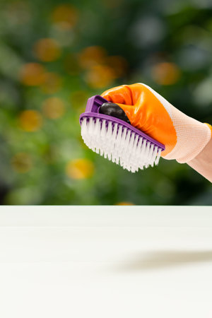 Close-up view of dentist's hands in latex gloves with a layout of the human jaw and a curette....