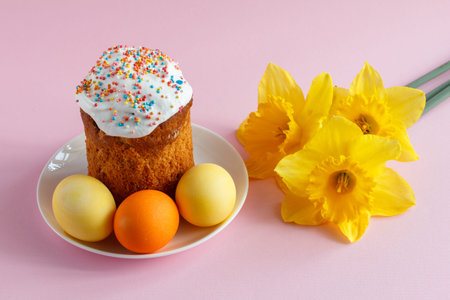 Easter cake and colorful Easter eggs with daffodil flowers. Traditional orthodox christian easter...