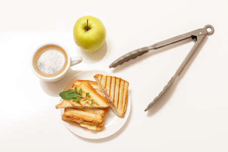 Homemade grilled cheese sandwich for breakfast with cup of coffee.の写真素材