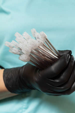 Dentists hand in glove with saliva ejectors.の写真素材