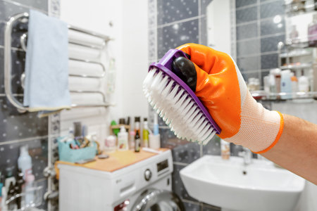 Mans hand in protective glove with brush.の写真素材