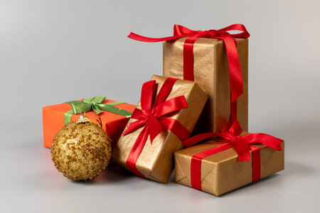 Christmas decoration. Gift boxes and a toy ball on the gray background. Christmas greeting card...