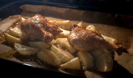 Roast duck with potatoes on a wooden board