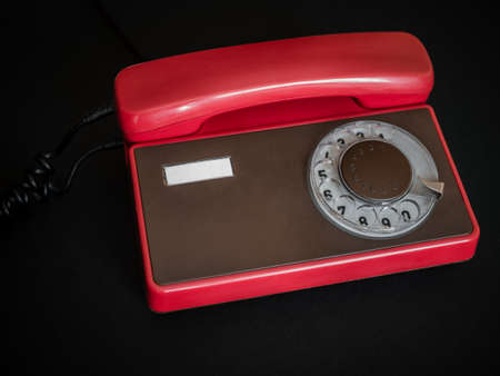 Red retro phone on dark backgroundの写真素材