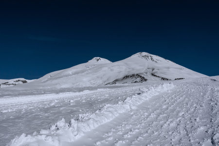 Amazing snowy mountain landscape of the Caucasus, peaks of mount Elbrus on a clear blue sky day