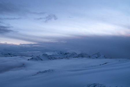 Caucasus Mountains above the clouds. View from Mount Elbrus