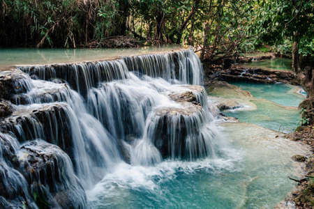 Amazing turquoise water of Kuang Si waterfall in tropical rain forest. laosの写真素材