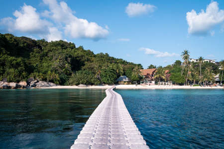 Floating bridge to beautiful beach. clear blue waterの写真素材
