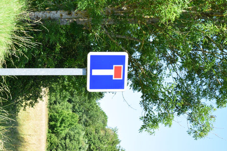 Traffic sign indicating the direction of the road, in the countrysideの写真素材