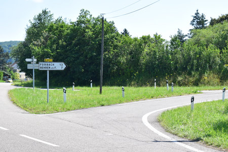 Road sign on the side of a road in the countryside in summerの写真素材