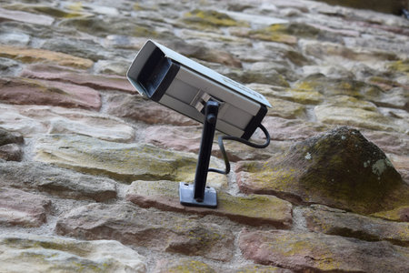 security camera on a brick wall, closeup of photo with shallow depth of field