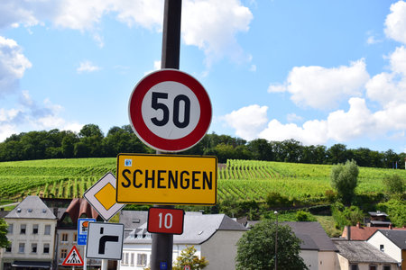 town sign of Schengen, Luxembourg with limit 50 located on the bridge crossing the Moselle and...