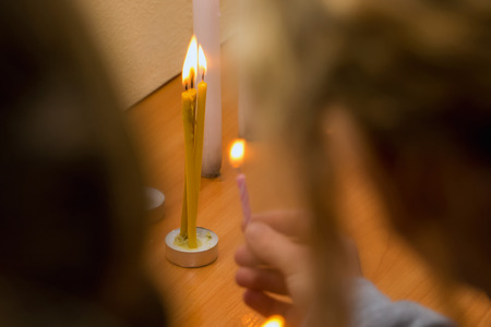 people lit candles and held in their hands in honor of the feast or in memory of the tragic eventsの写真素材