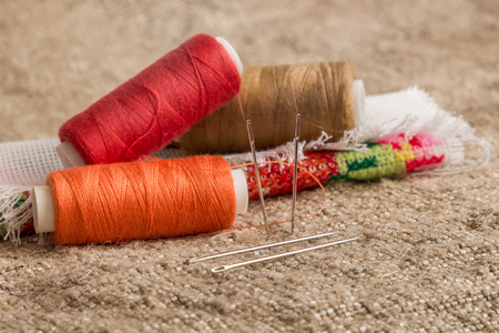set for sewing and needlework: fabric, multicolored threads, needles,の写真素材