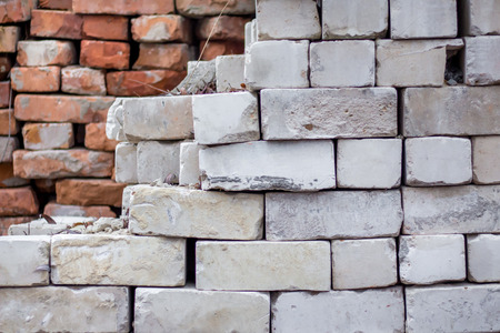 folded old orange brick, in the foreground white brick, for repair and constructionの写真素材