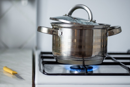 on the home gas stove preparing food in a metal panの写真素材