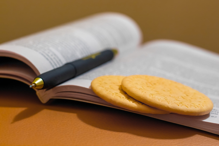 cookies near  book for  quick snack during trainingの写真素材