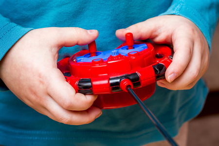  boy holds  toy control panel, mastering modern technologiesの写真素材