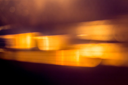 Blurred abstract background with blurry orange stripes on  dark backgroundの写真素材