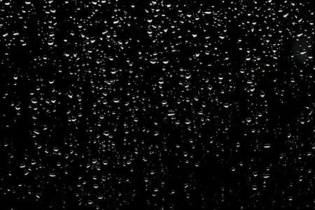 Drops of rain on dark glass. Background for design and creativity