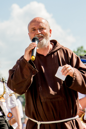 Ukraine. Khmelnytsky region. June 2018. Sermon of the Catholic priest during the holidays of the family. Catholic priest with a joyful expression of the faceのeditorial素材