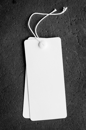 Blank price tag with copy space isolated on black backgroundの写真素材
