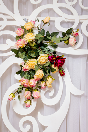 Composition of roses on a light background of decorative elements. Decor for celebrationsの写真素材
