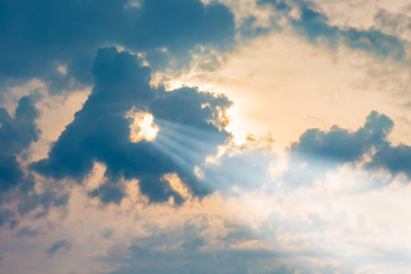 The ray of sun penetrates through the cloud in the evening sky. The sky during sunset