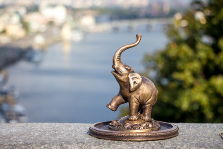 Figurine of an elephant in Kiev on the background of the Dnieper Riverの写真素材