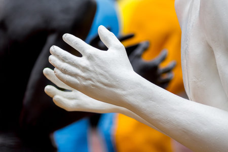 Khmelnytskyi. Ukraine. October 2018. Sculptures by Viktor Sidorenko. Hands of people with white and...