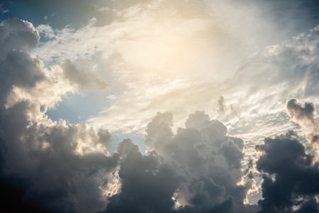 Dark dramatic clouds and glare of light in the evening sky