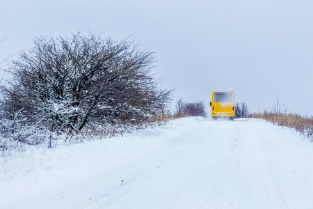 The bus moves along the snowy road in the winter. Winter tourismの写真素材