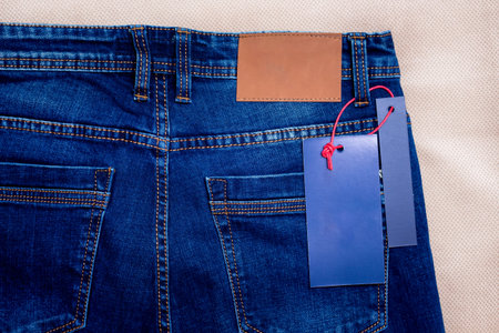 Blue jeans with labels. Sewing and selling jeans