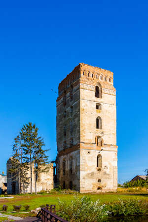 Ruins of a defensive tower in the city of Starokonstantinov, Ukraine, against the background of a blue skyの写真素材