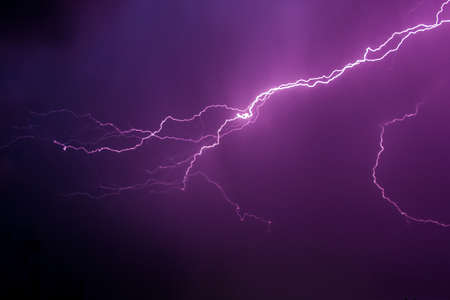 Lightning in the dark sky during a thunderstorm nightの写真素材