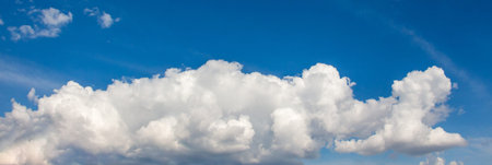 Fluffy white cloud on a blue sky, panorama