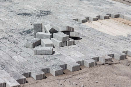 Laying gray paving tiles in the city. Repair of pavementの写真素材