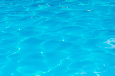 Clear transparent light blue water in the pool. Texture, water background in the pool