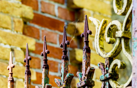 Decorative iron grill on on the background of a stone wall