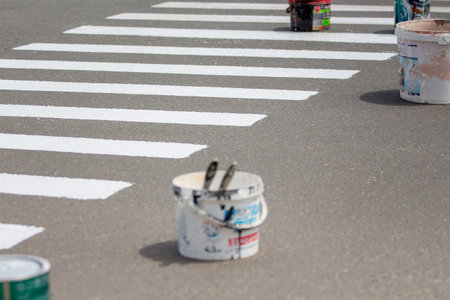 Pedestrian crossing and bucket with paint on the road