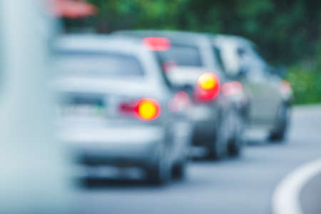 Blurred background: cars on the road with side lights onの写真素材