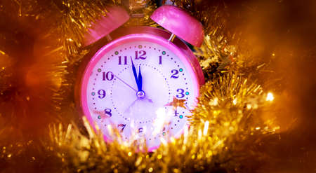 The clock among the Christmas decorations shows the approach of the new yearの写真素材